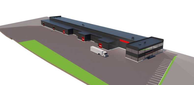 Pitkänmallinen tumma rakennus, jonka edustalla kulkee rekka. Oikeassa päässä rakennusta on isoja lasi-ikkunoita.