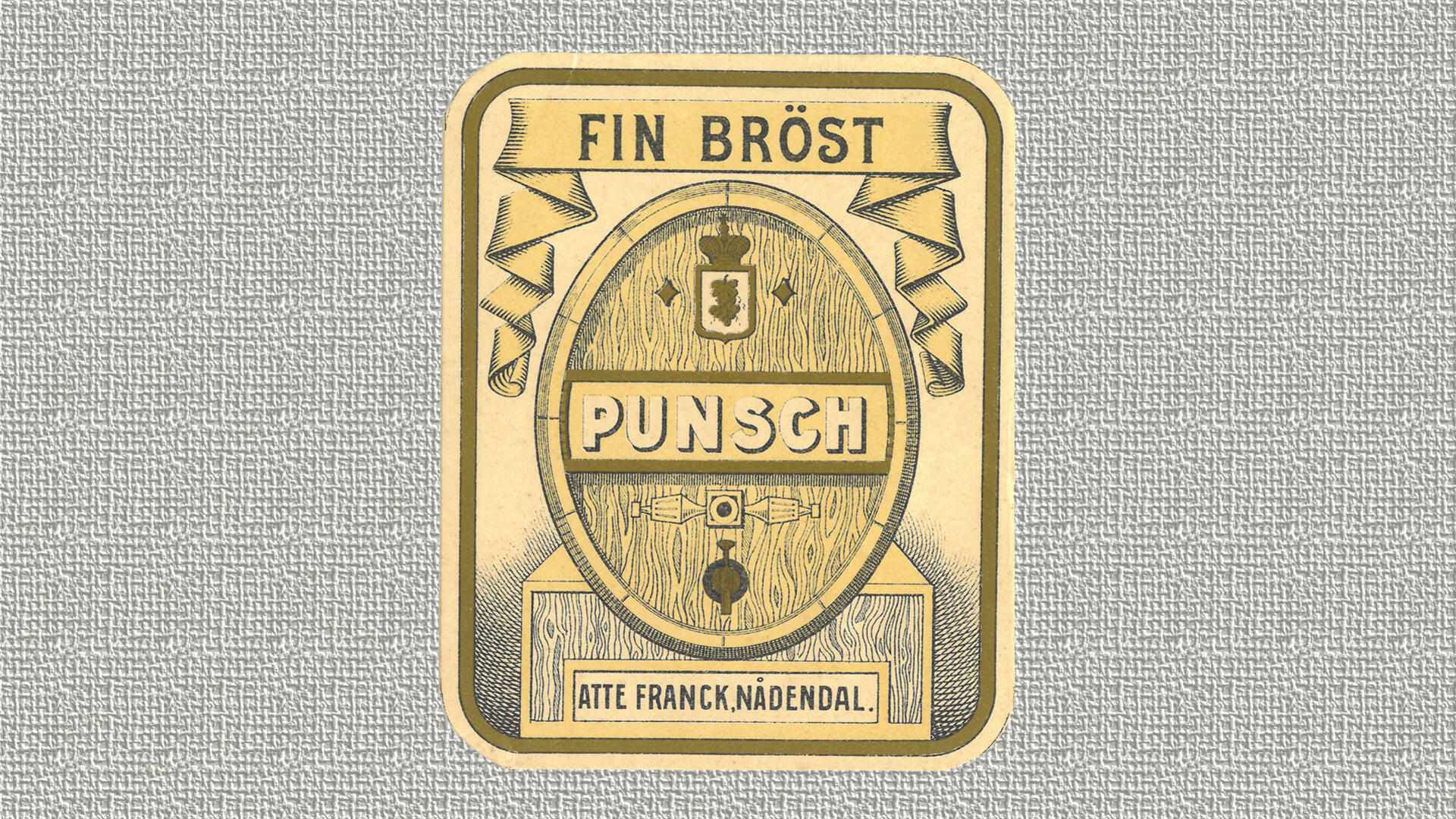 harmaalla taustalla vanha punssipullon etiketti