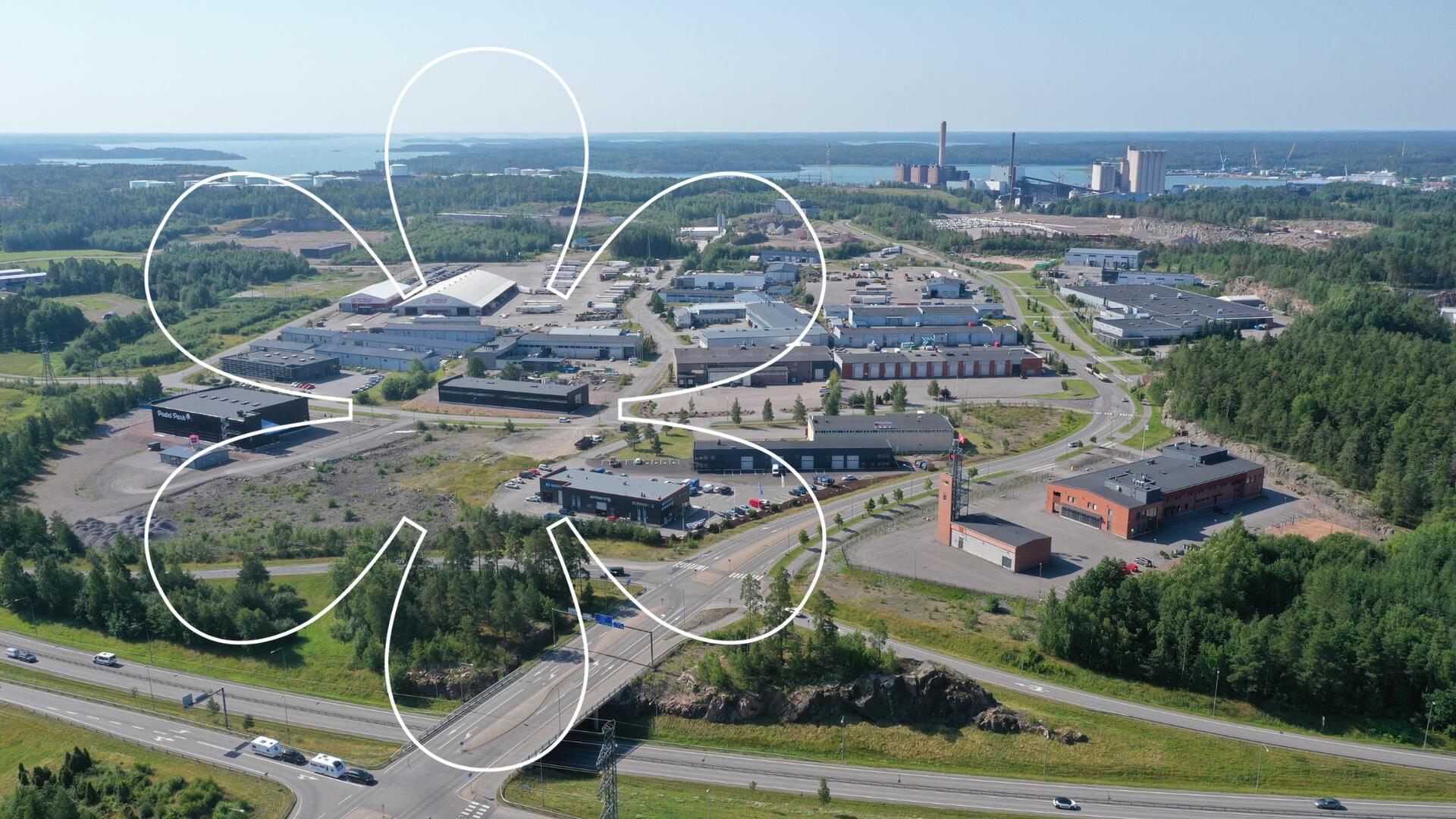 Luolalan yritysalueen isoja hallirakennuksia. Onnellinen aurinko -elementti.