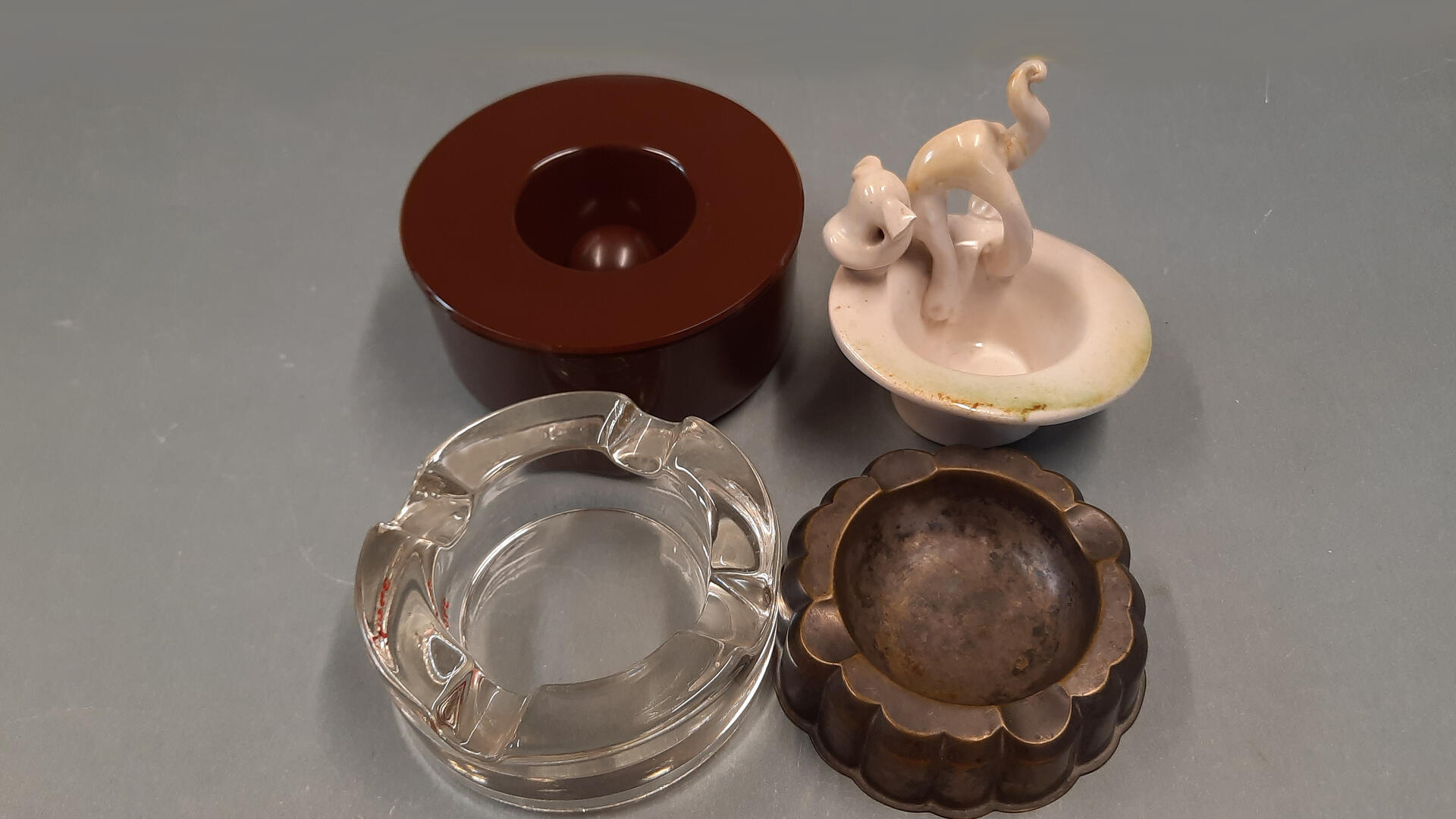 neljä tuhkakuppia harmaalla taustalla