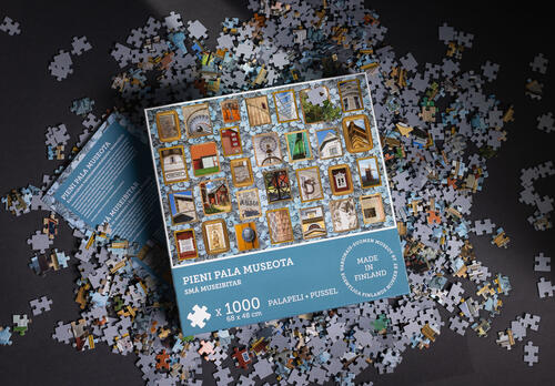 palapeliarasia ja palapelin paloja pöydällä